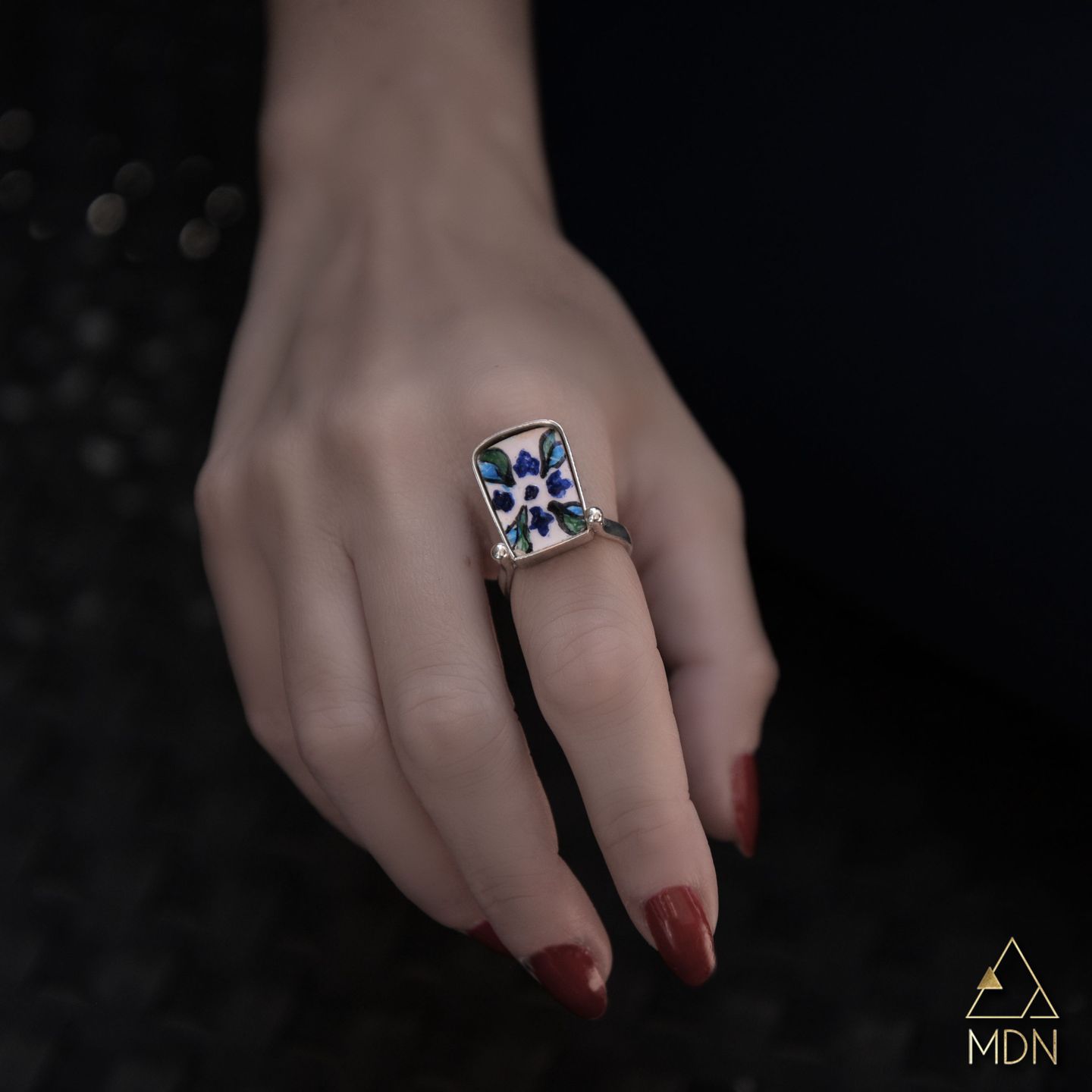 Mosaic inlay ring with blue and white design.