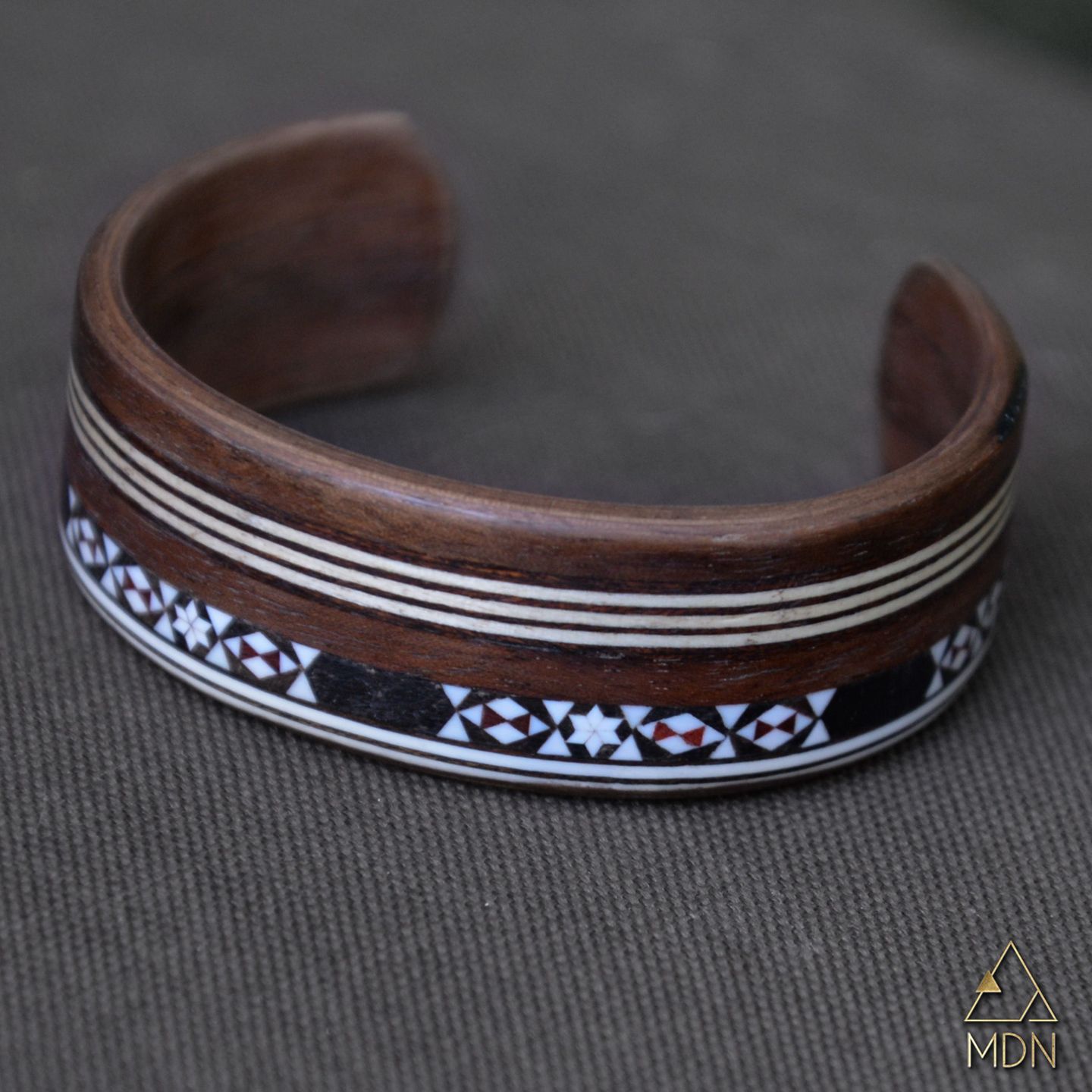 Cuff bracelet with dark wood and white geometric stripe inlay