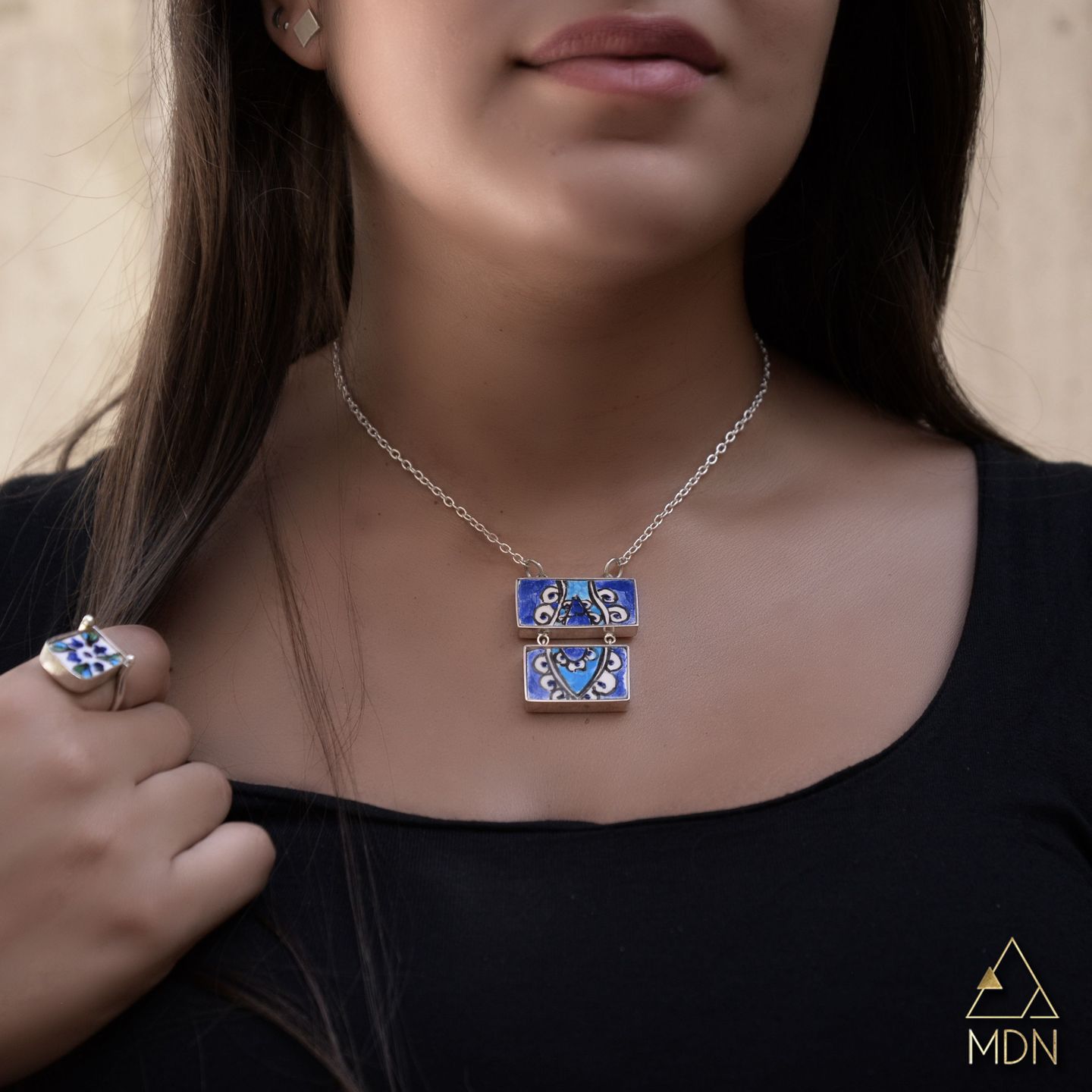 Square pendant necklace with blue and white mosaic inlay.