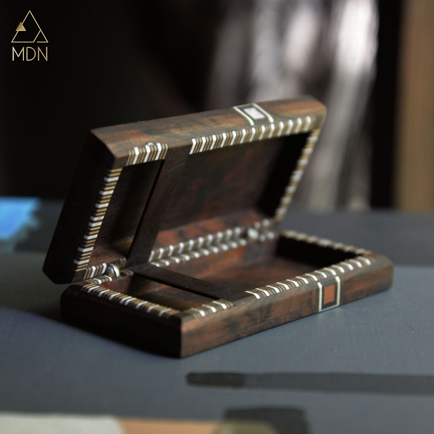 Wooden box with mosaic inlay pattern and metal bands