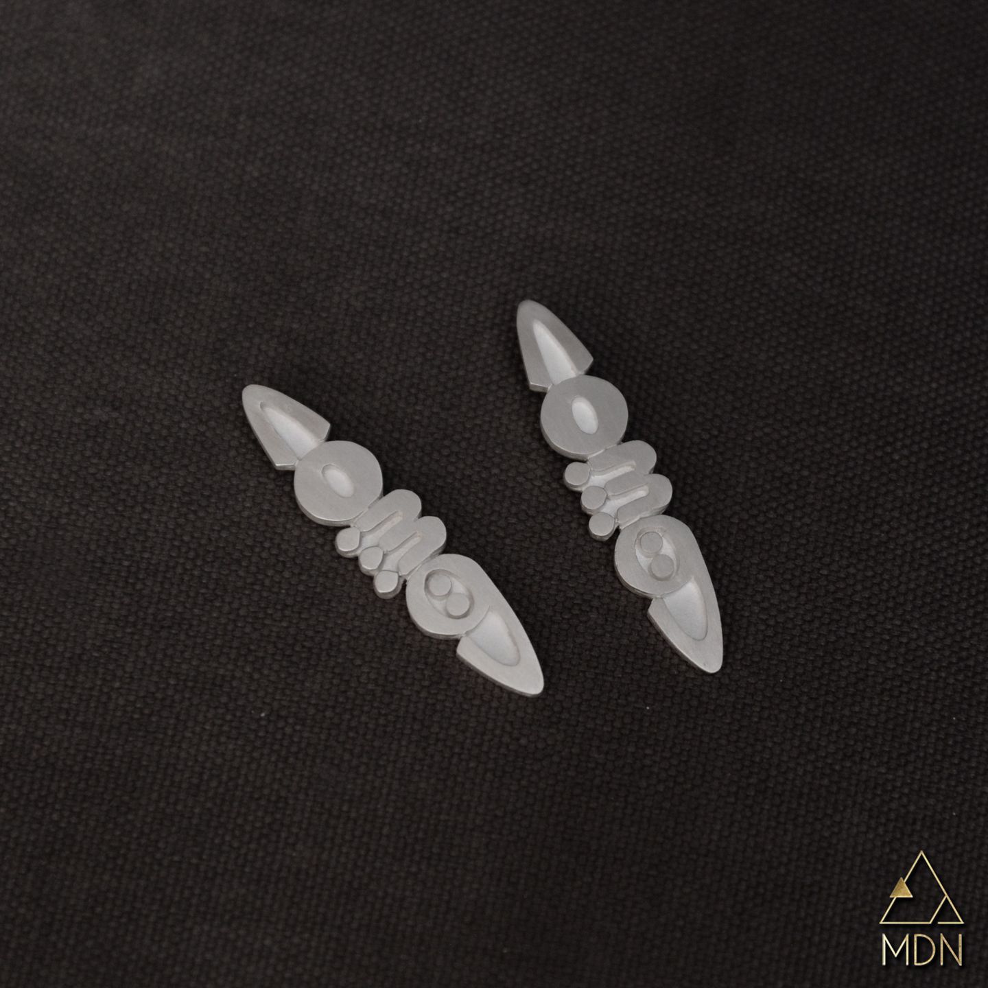 Pair of leaf-shaped pendants in translucent white-toned stone.