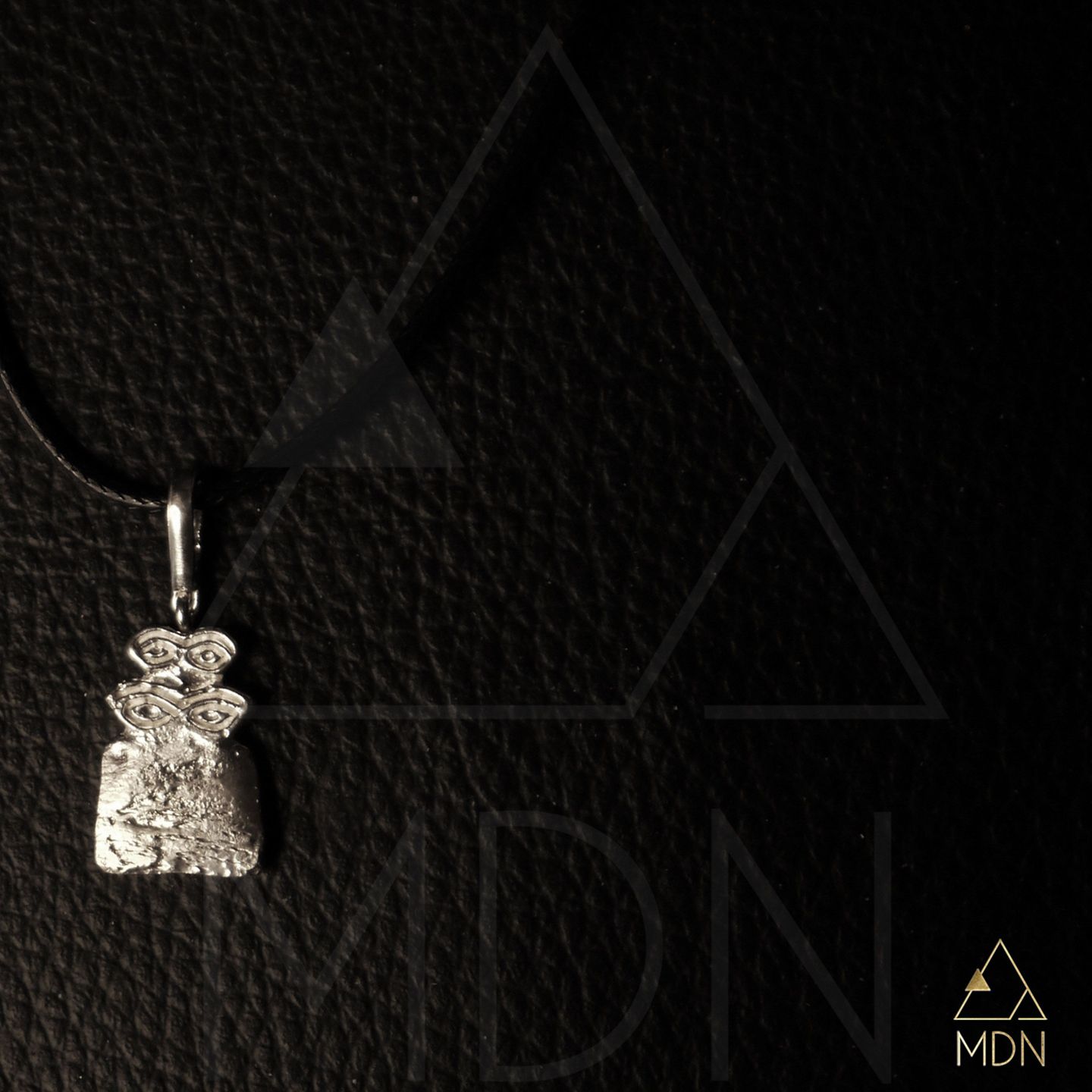 Rectangular hammered metal pendant.