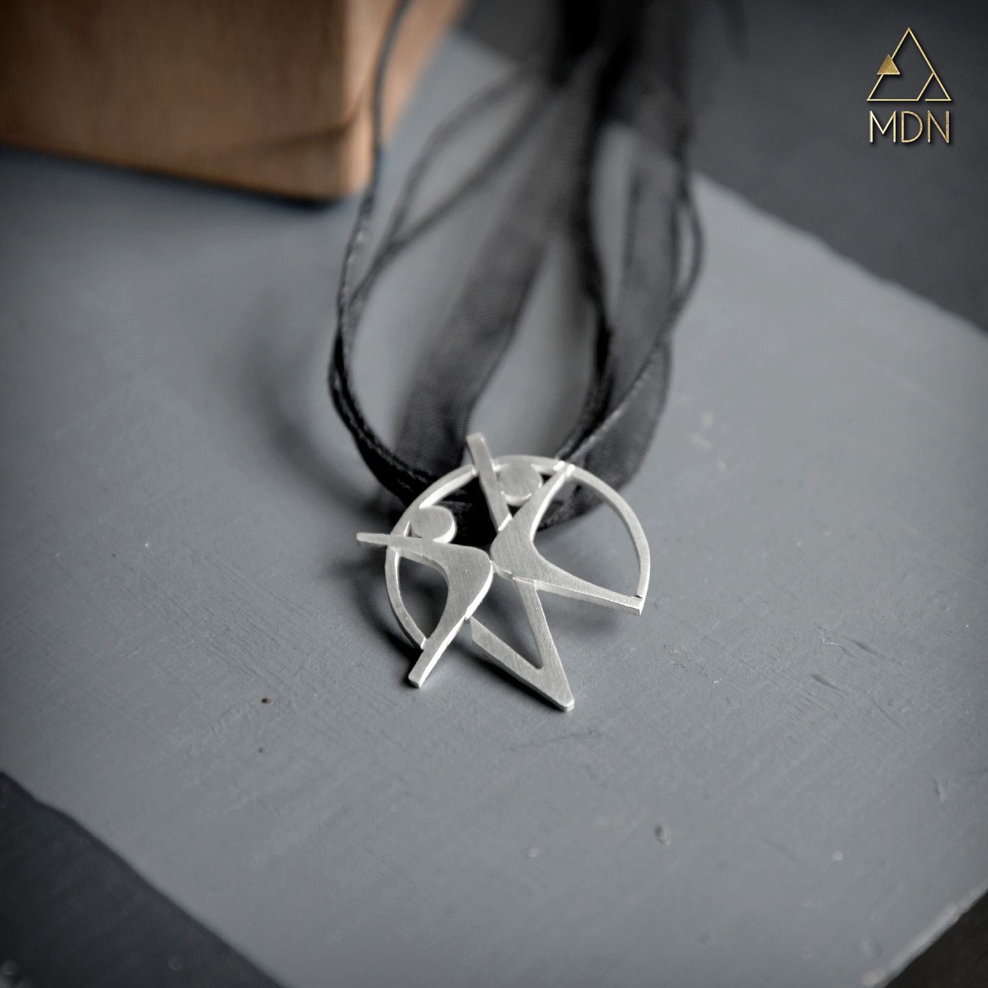 Pendant rendering the name Ghazal in Arabic calligraphy.