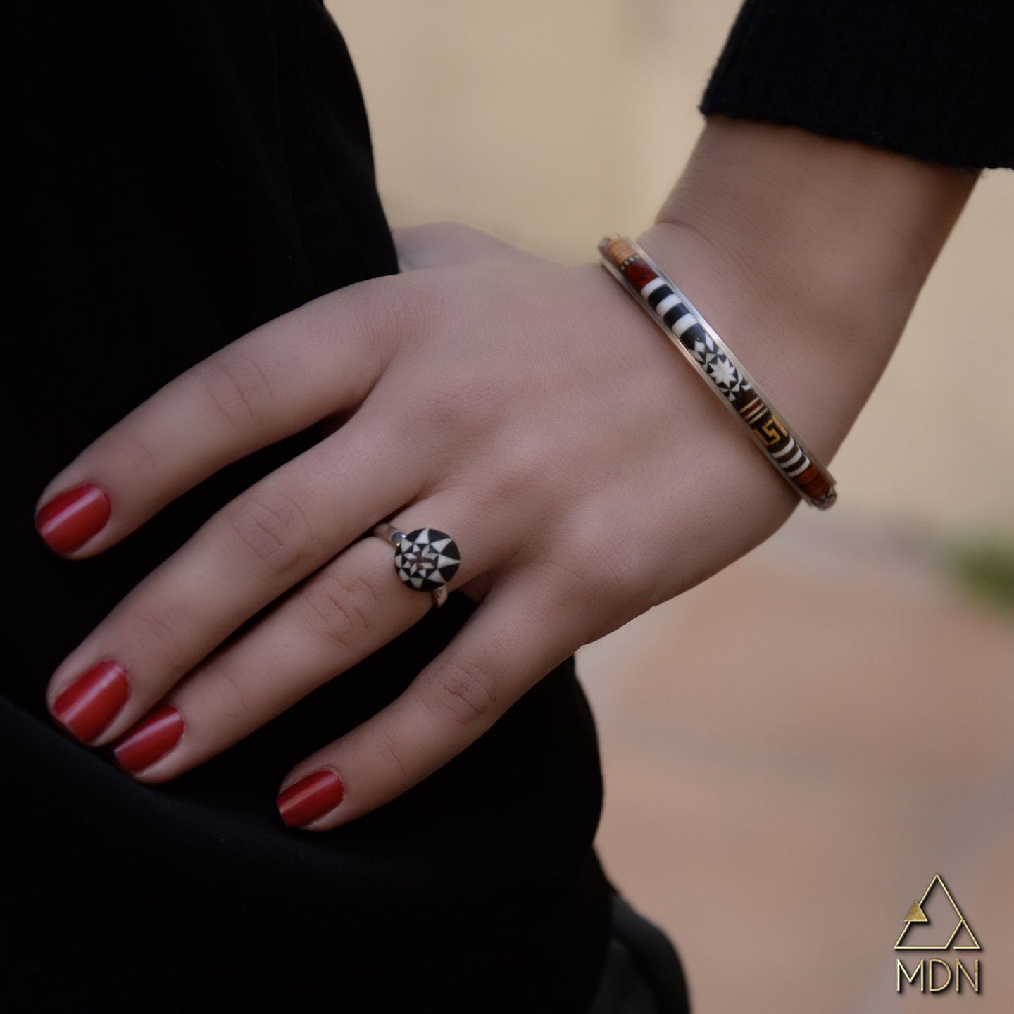 Bracelet with mosaic inlay and silver-toned geometric accents
