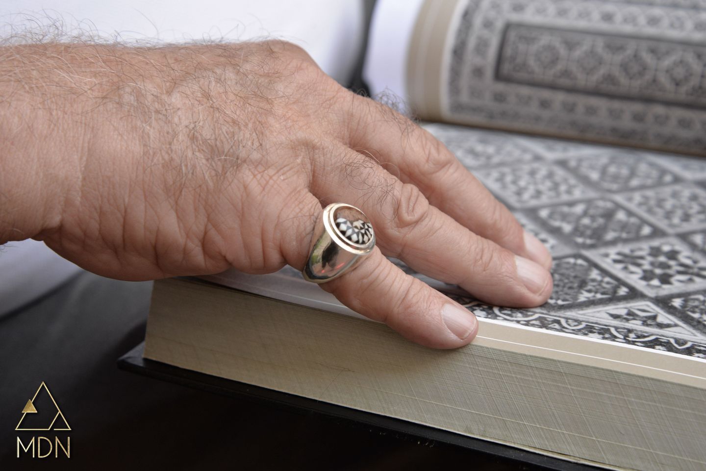 Ring with silver-toned geometric textured pattern