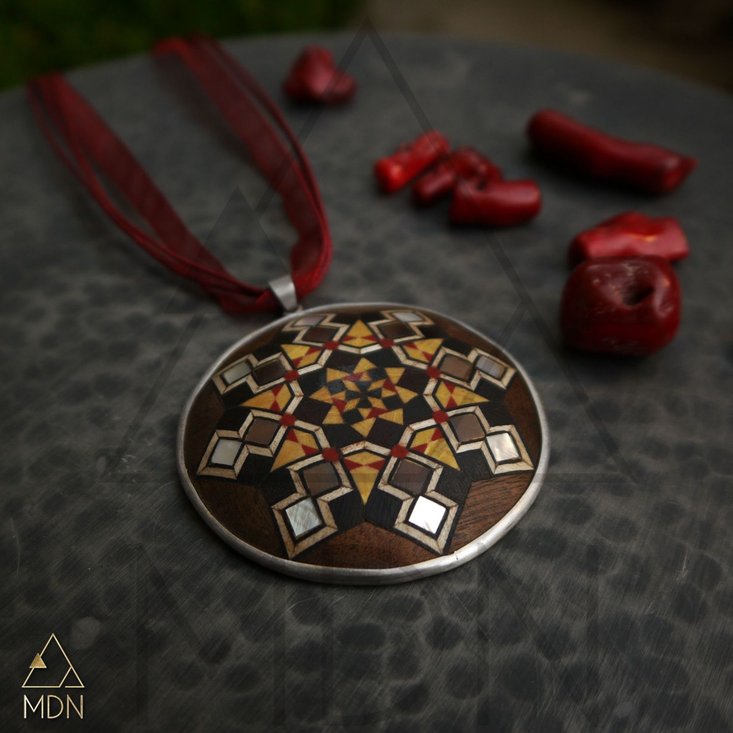 Pendant with wood mosaic inlay and geometric chain