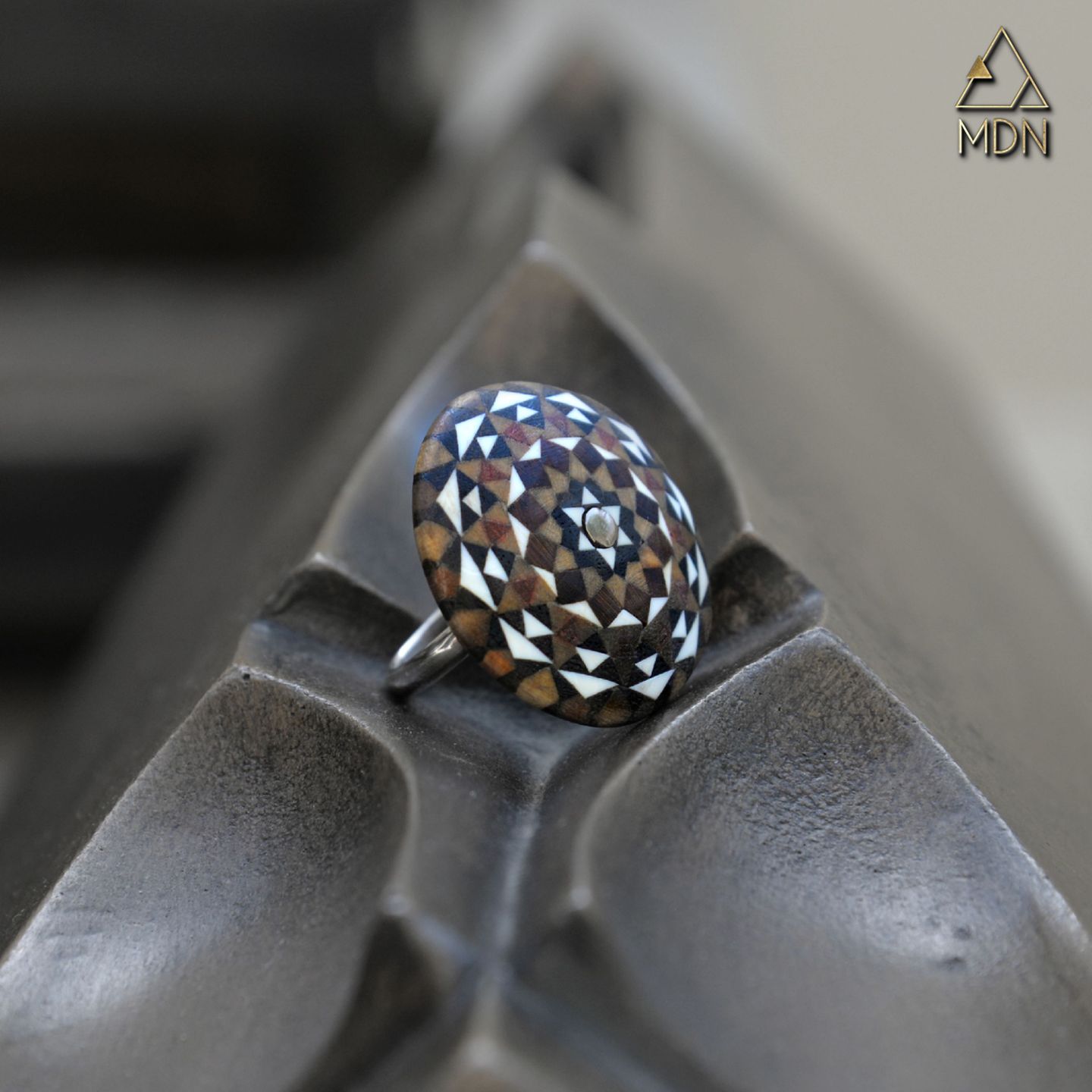 Ring with mosaic inlay geometric pattern in blue, brown and white.