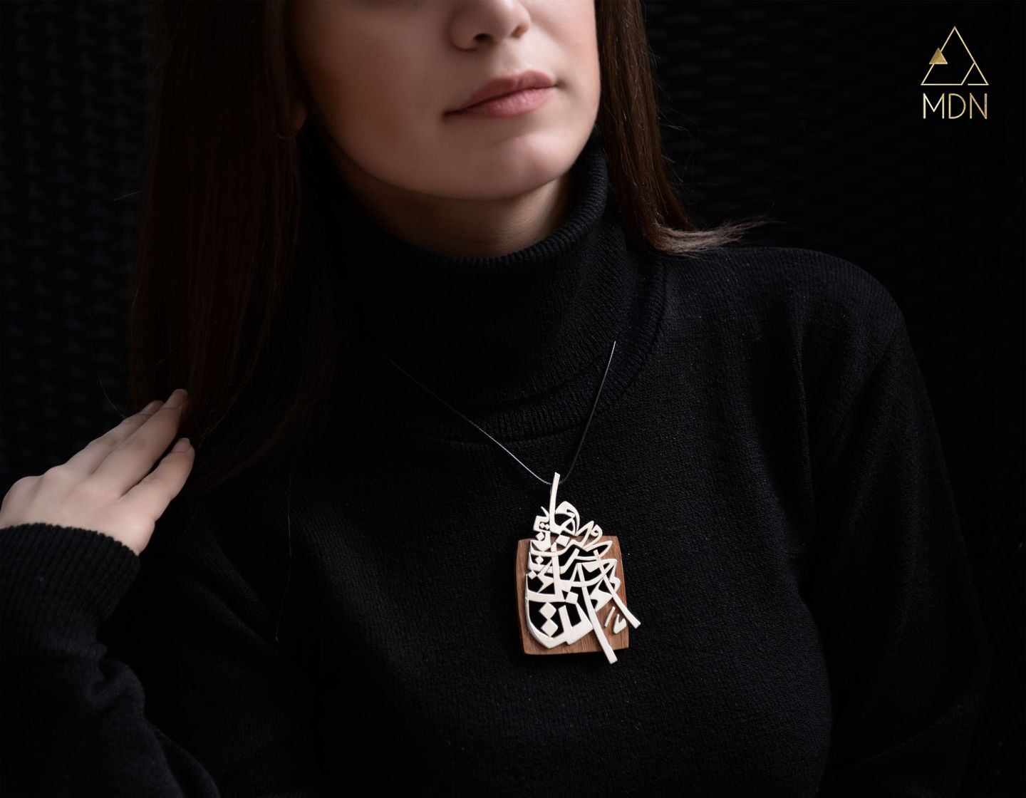 Rectangular pendant with Arabic calligraphy.