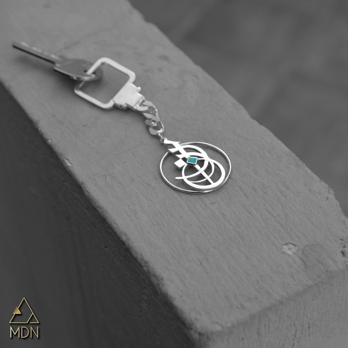 Keychain rendering the name Razan in Arabic calligraphy with turquoise.