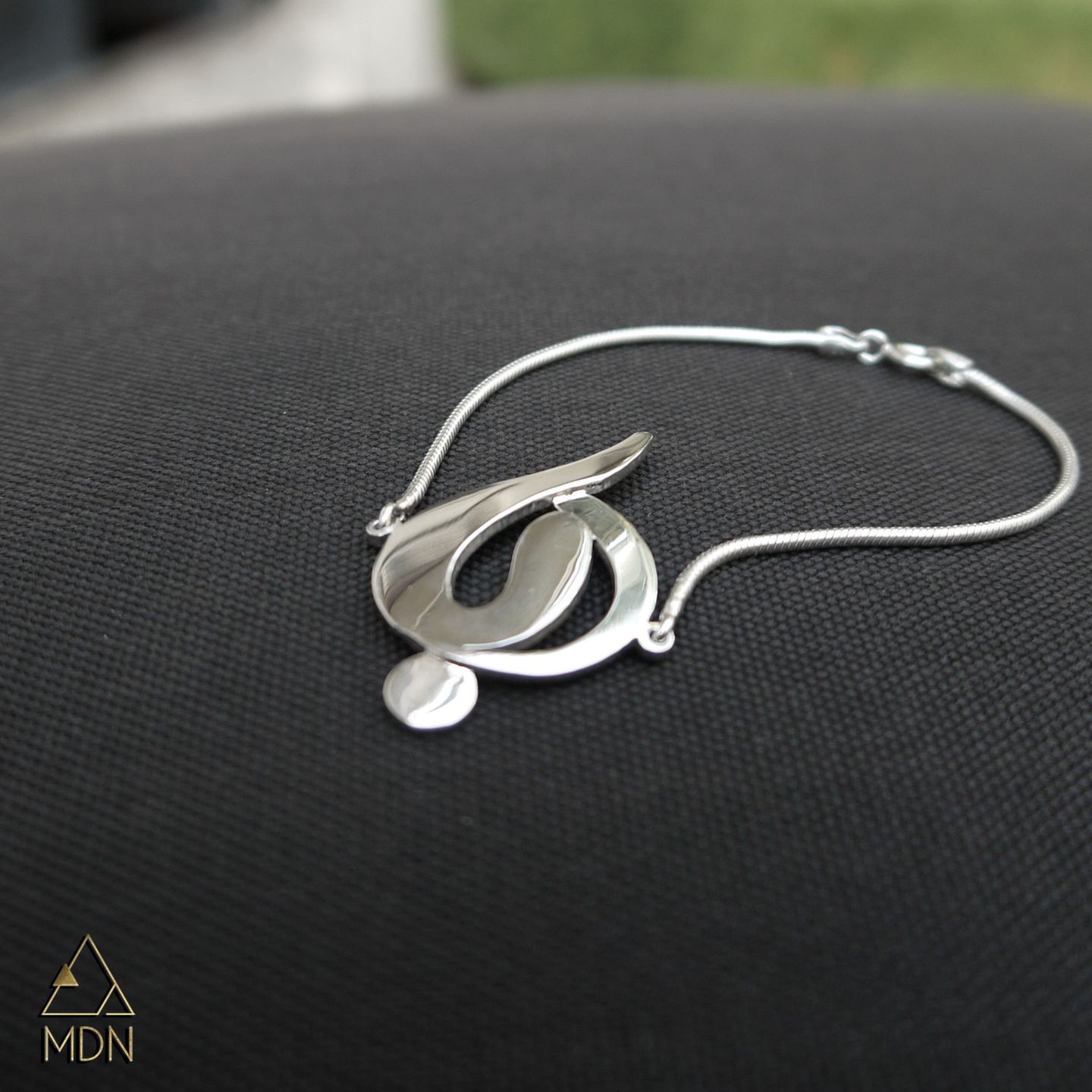 Bracelet rendering the name Ruba in Arabic calligraphy.