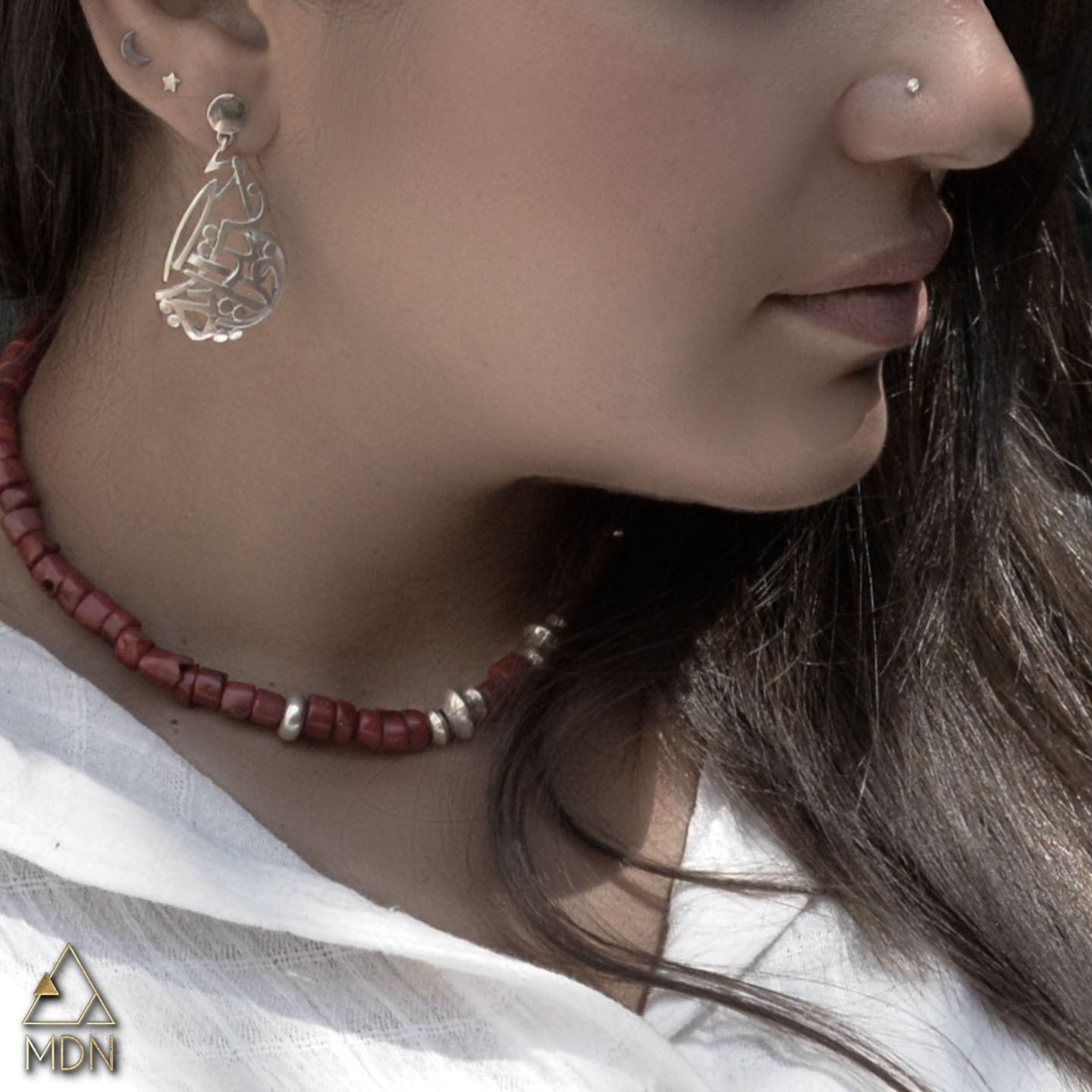 Earrings with Arabic calligraphy "انت بداية روحي" and burgundy necklace.