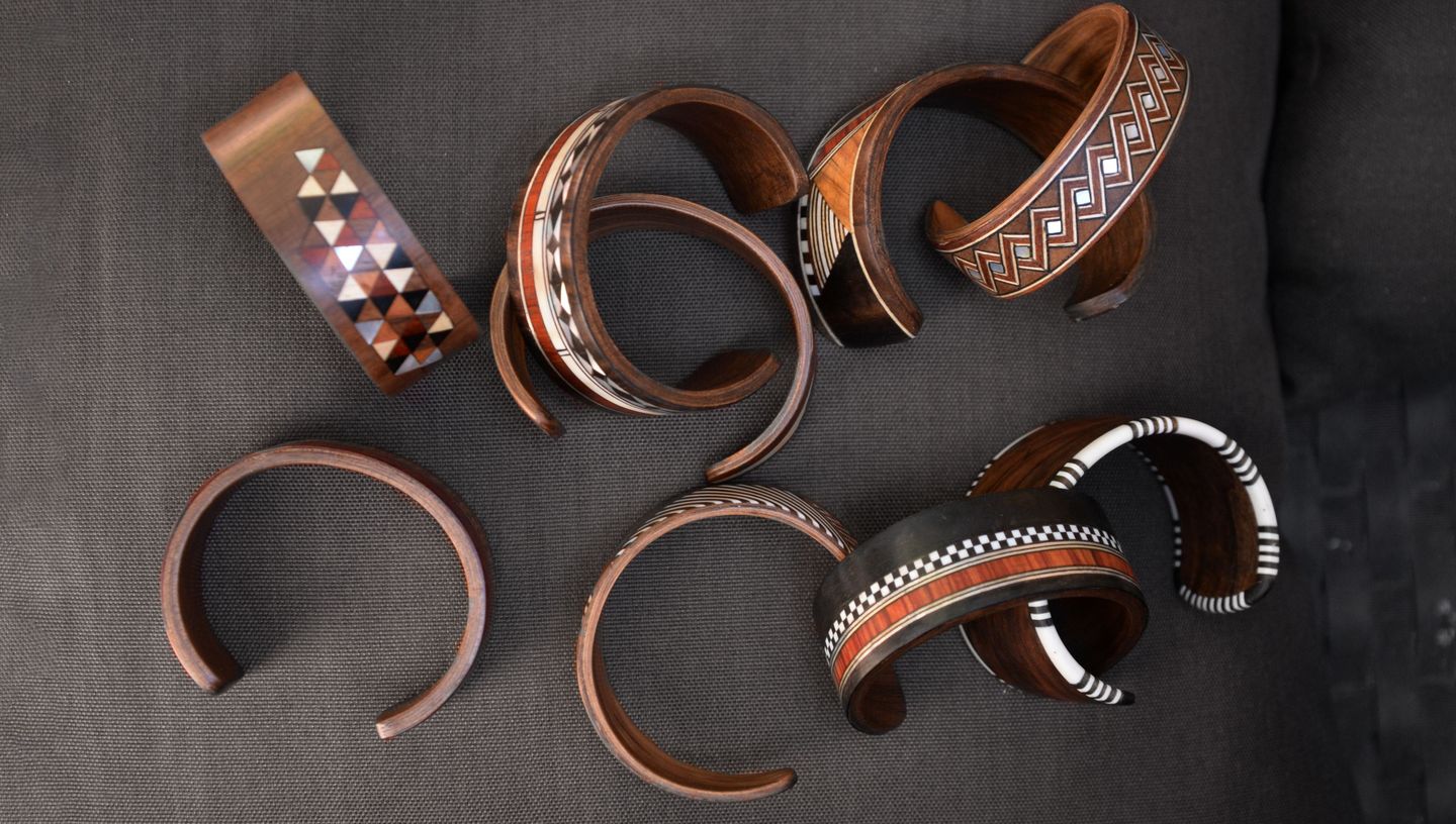 Collection of copper-toned bangles and cuffs in varying geometric patterns.