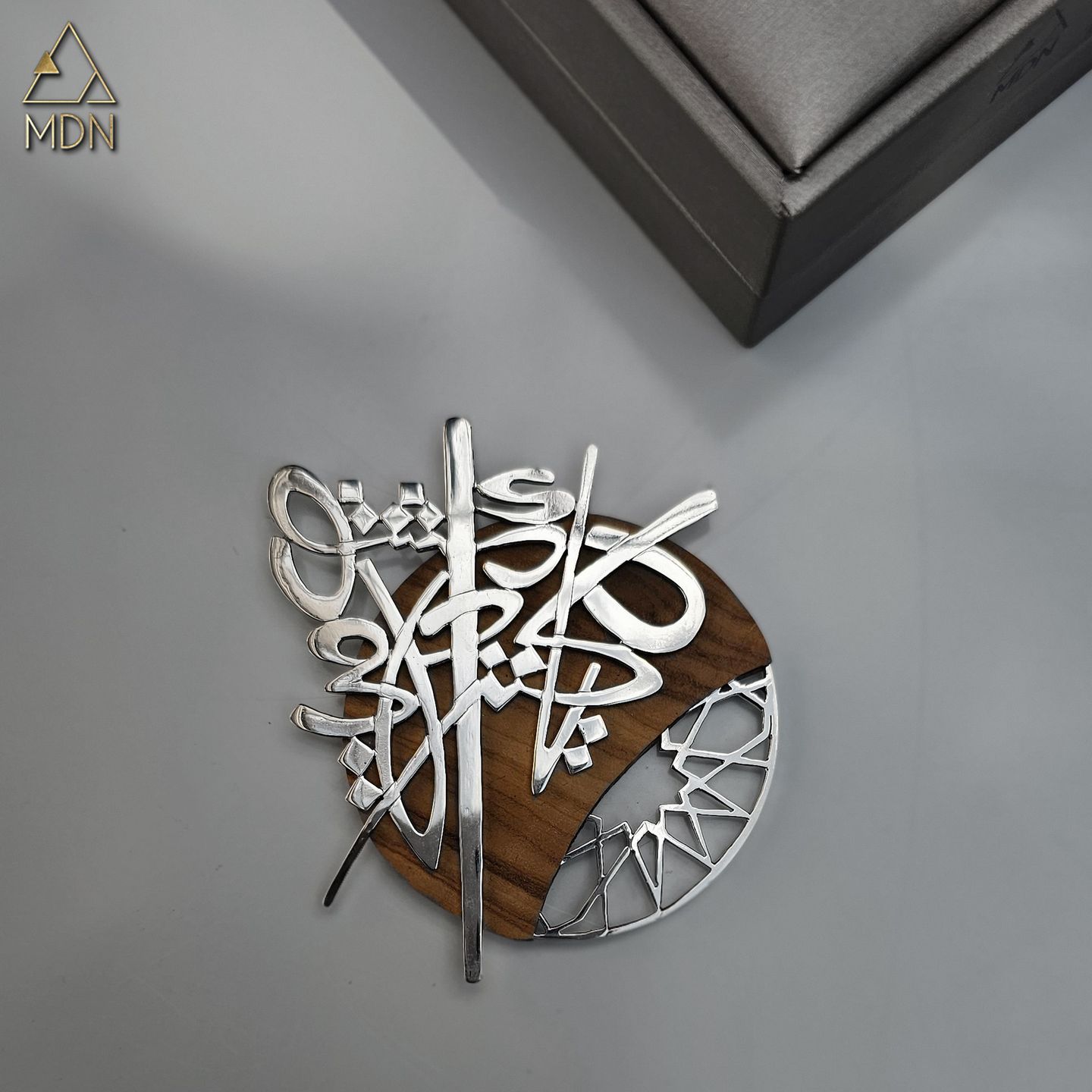 Pendant with Arabic calligraphy "دمشق يا كنز احلامي" and wood backing.