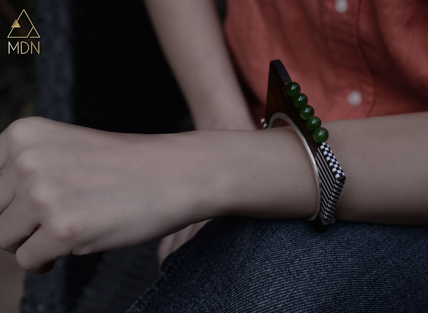 Bracelet with dark wood inlay and green stone accents